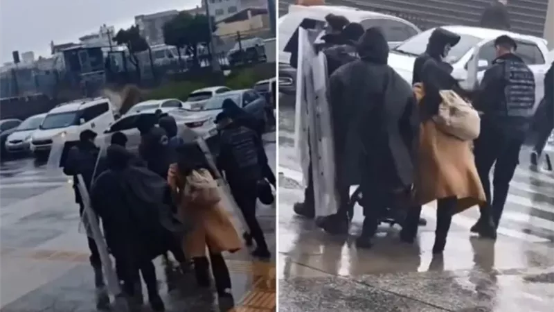 درع إنساني وسط العاصفة.. مشهد مؤثر للشرطة التركية| فيديو 
